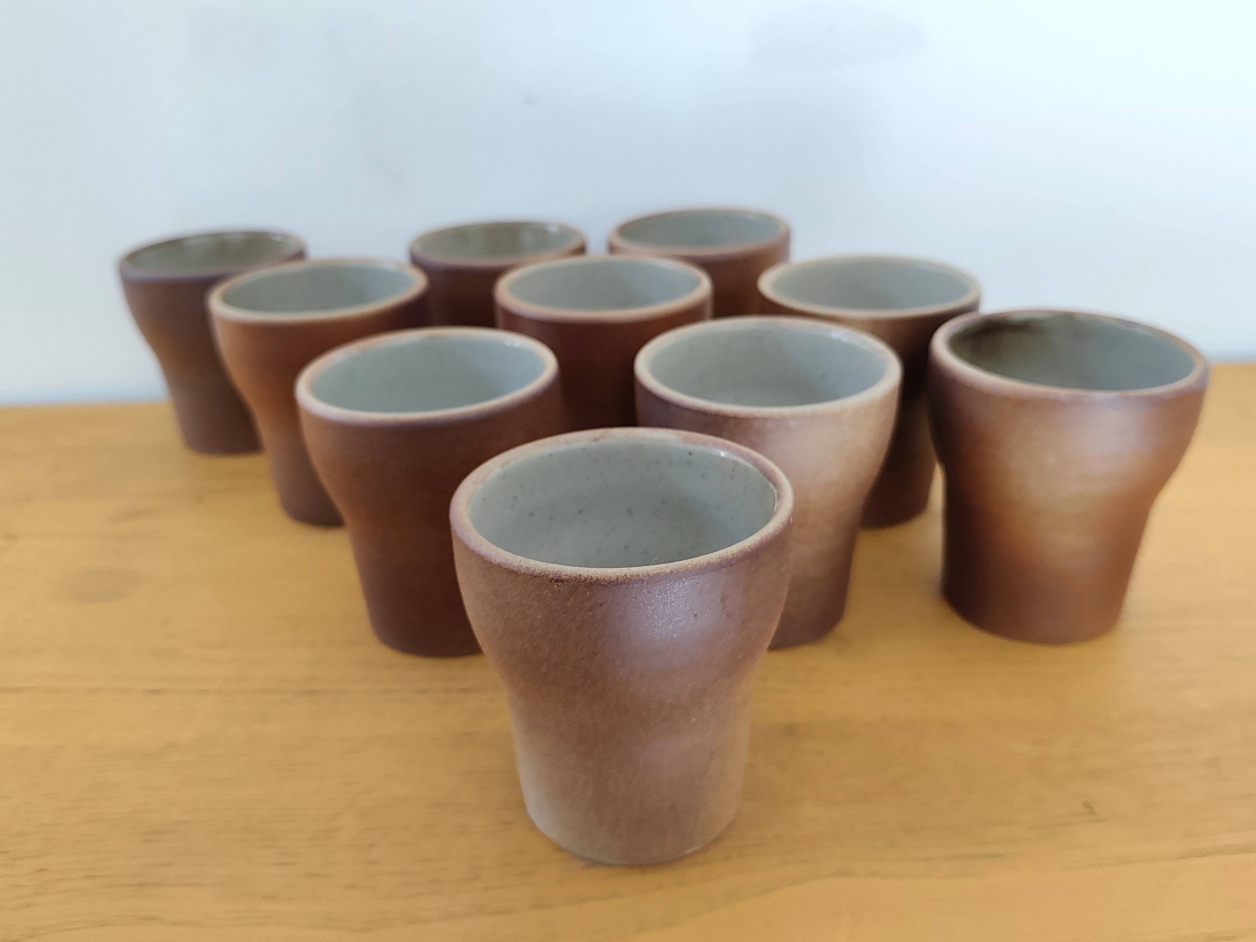Stoneware cups – Armor stoneware set of 10 and an 11th French stoneware cup.