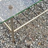 Vintage coffee table in gold and blackened metal with glass top from the 60s