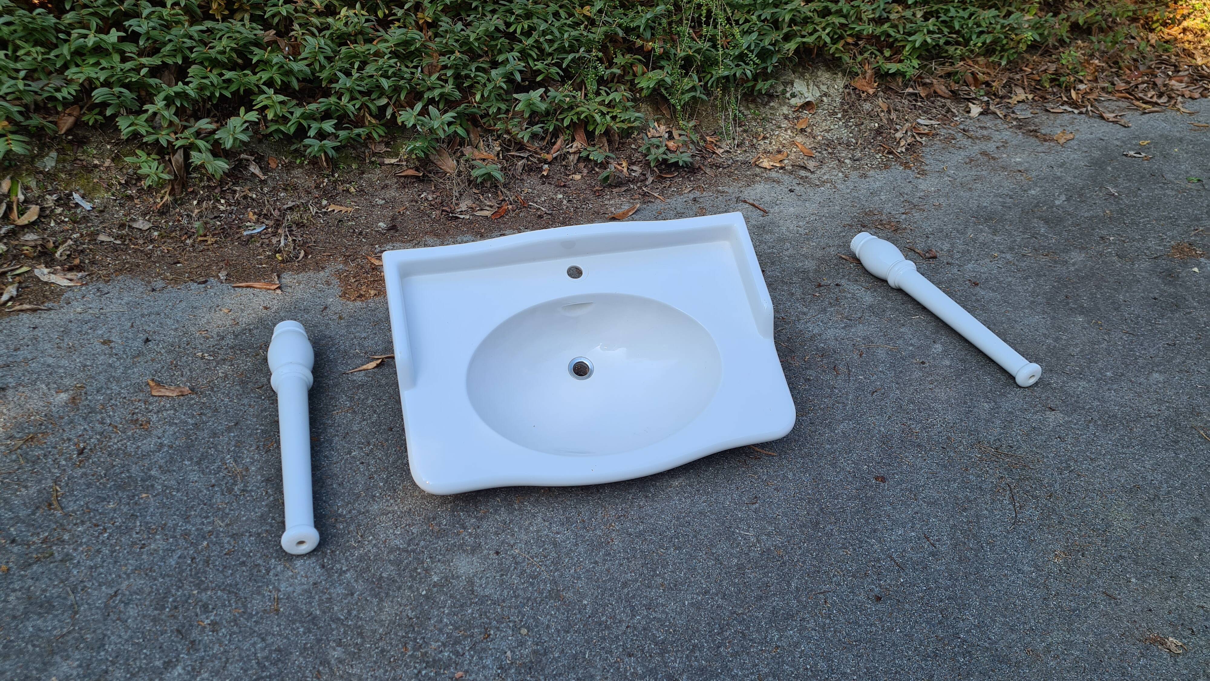 White ceramic wall washbasin with 2 ceramic legs