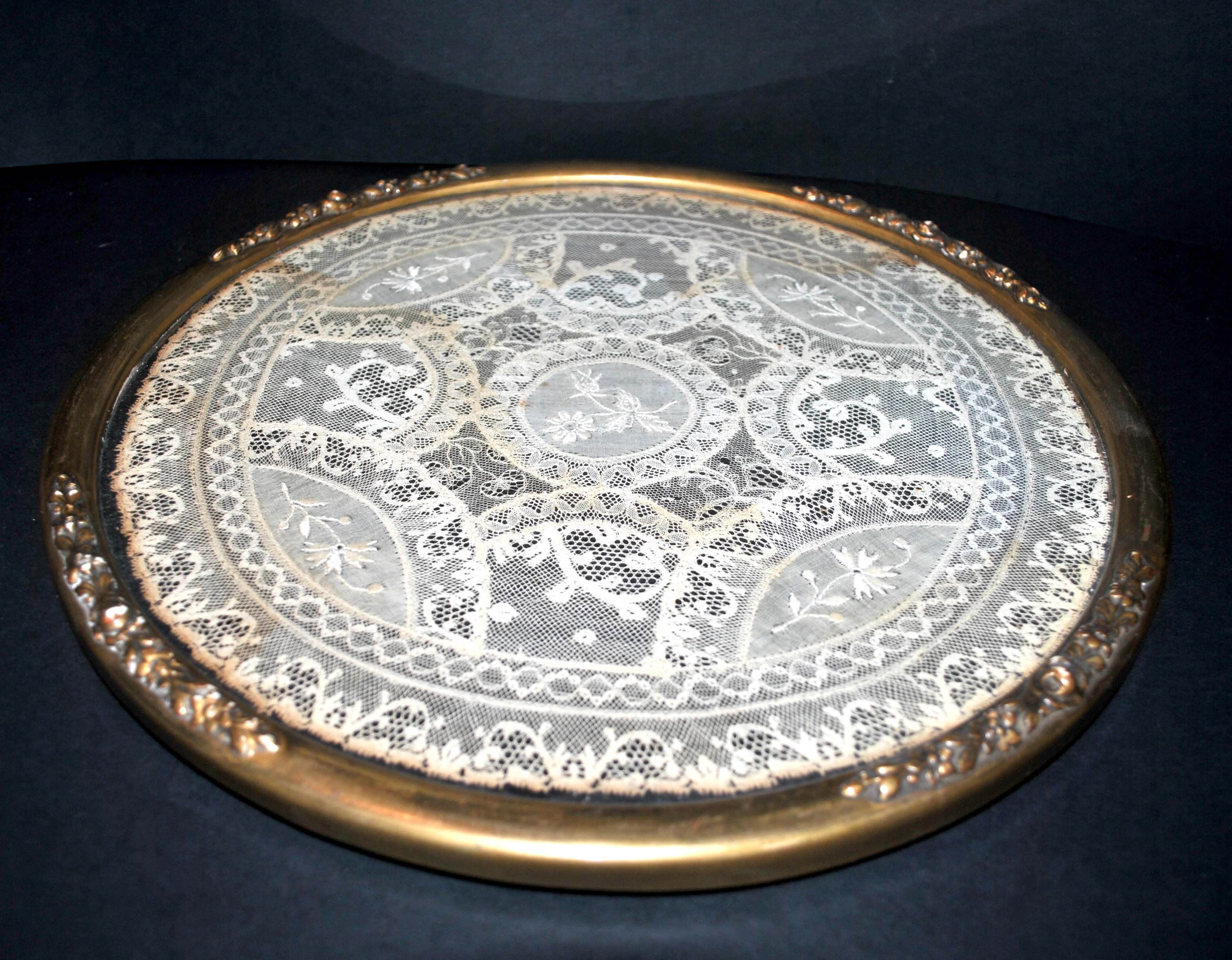 Antique lace top under glass and gilded stucco frame
