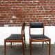 Set of 2 vintage Scandinavian chairs in wood and black faux leather.