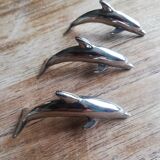 Set of three silver metal dolphin place markers