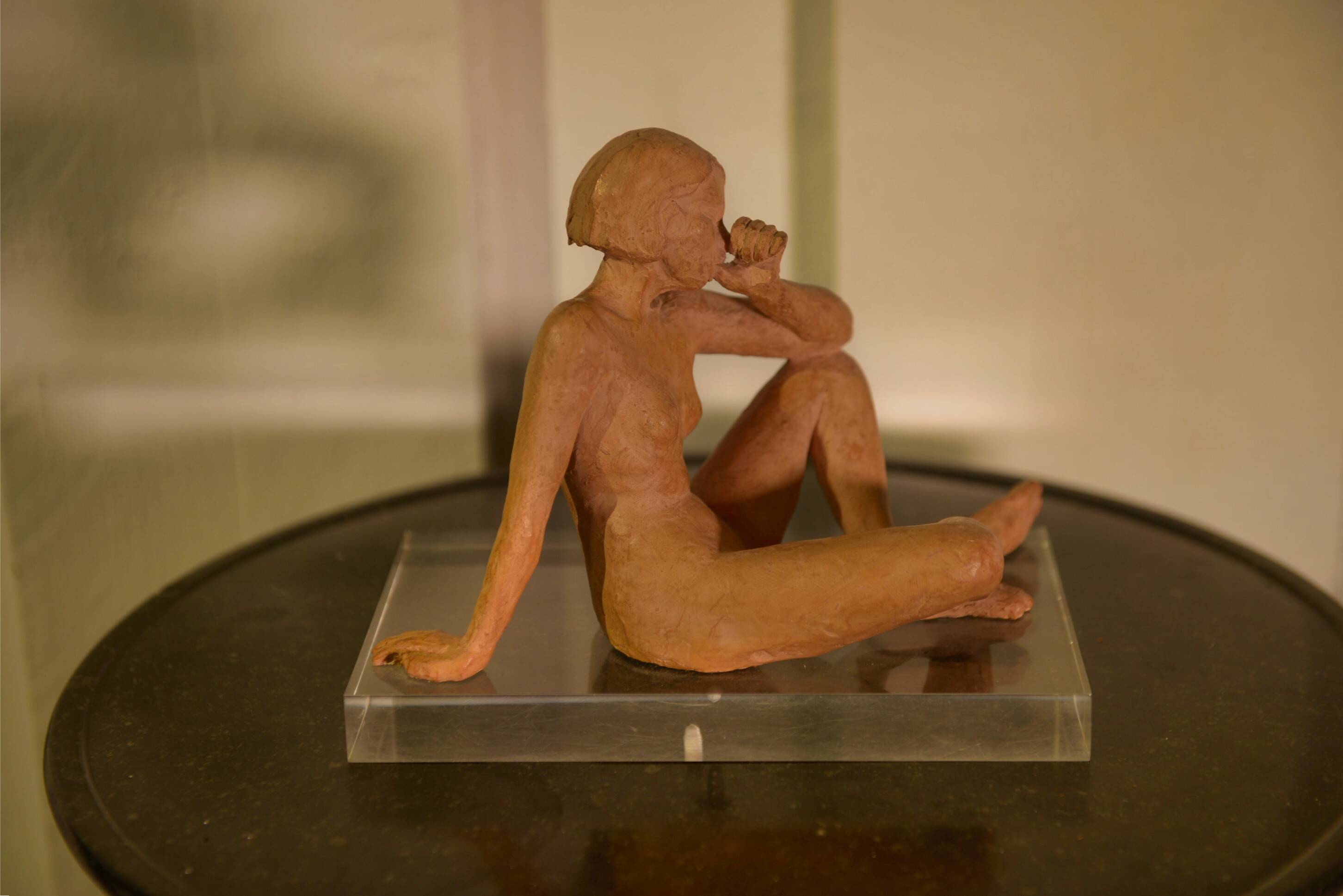 Terracotta sculpture of a seated woman by Norbert Treca contemporary art.