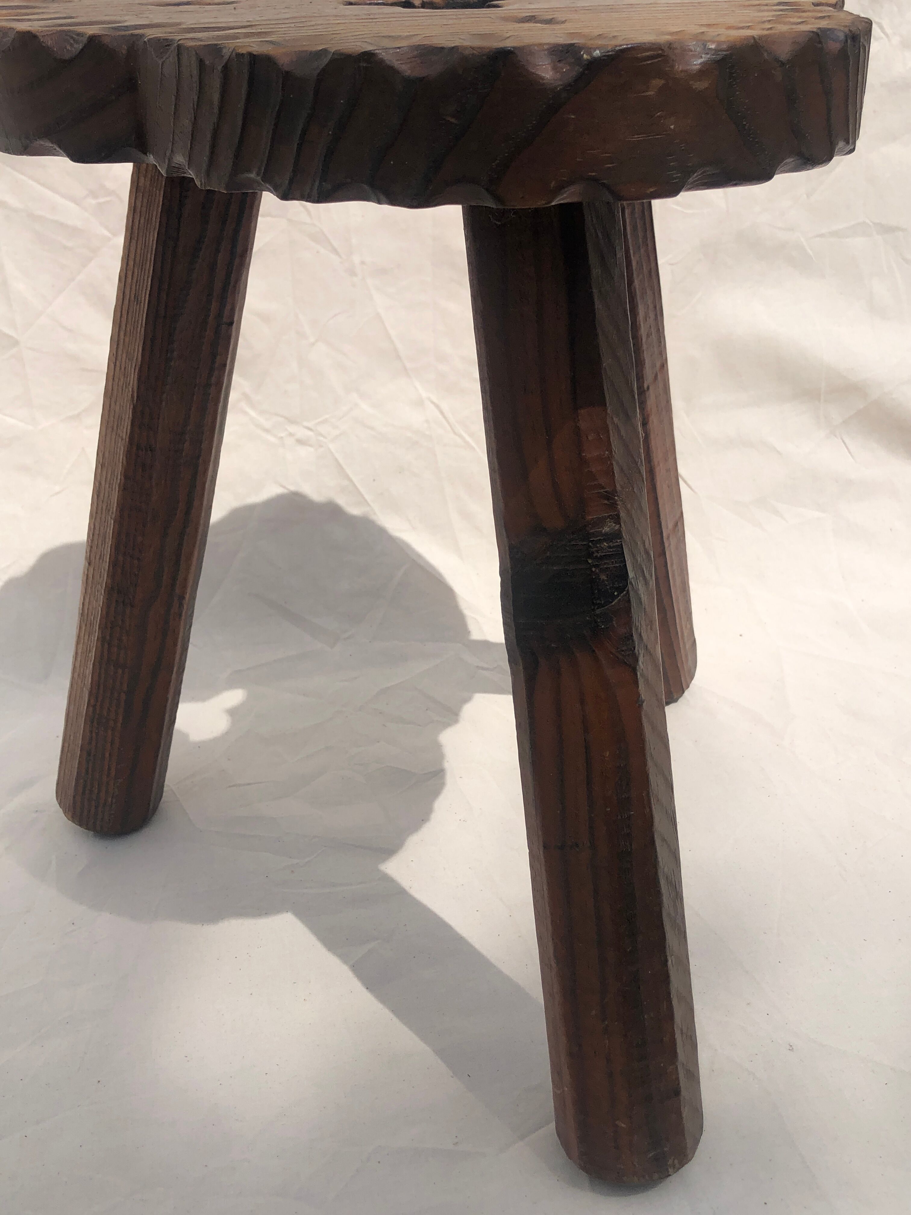 Chiseled wooden tripod stool