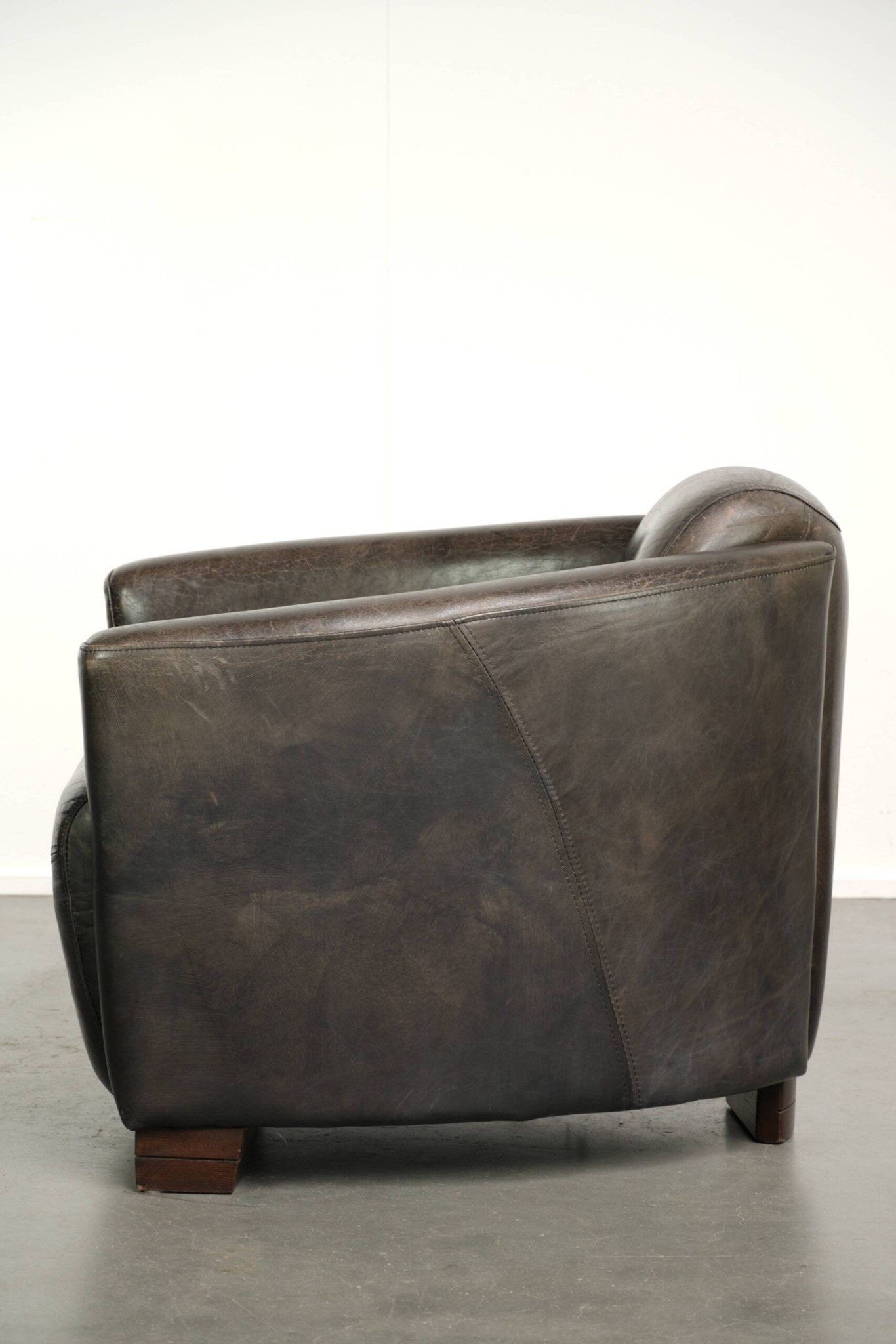 Cow leather Aviator design armchair in a dark colour scheme