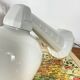 Swan neck wall light in ceramic with an opaline white glass globe.
