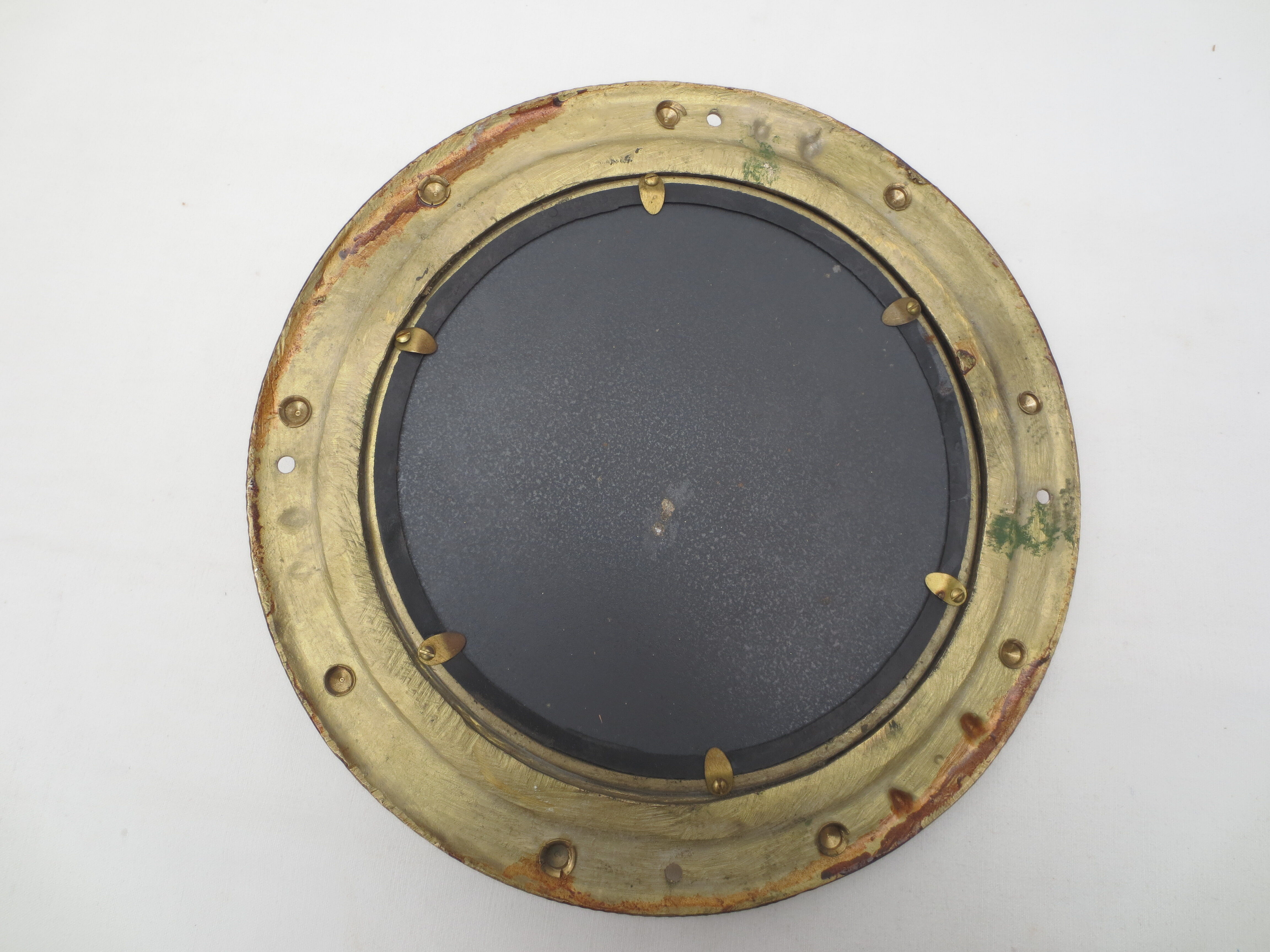 Mirror integrated into a brass navy porthole