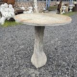 Cement garden table with trunk-shaped foot