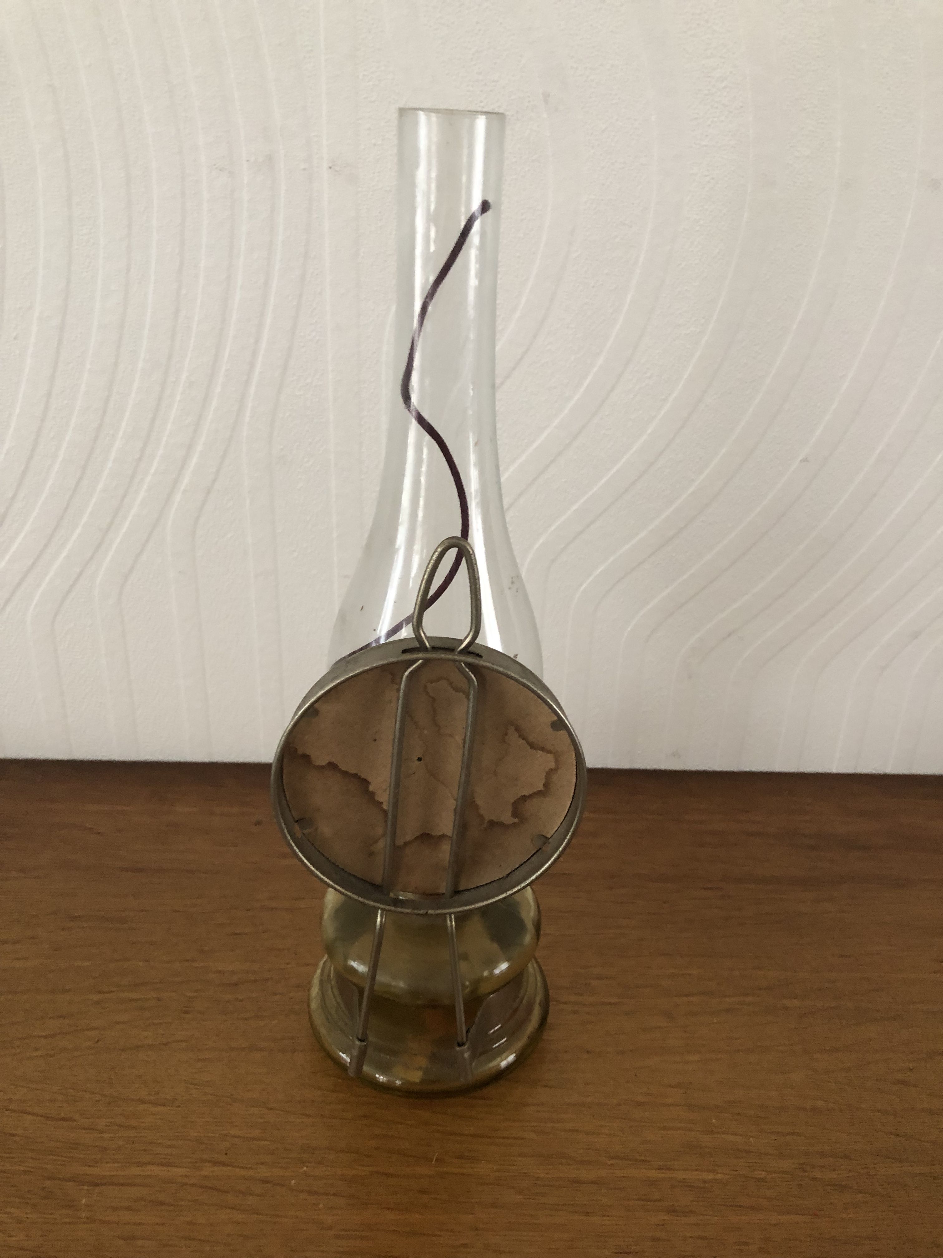 Oil lamp with glass pedestal and integrated round mirror