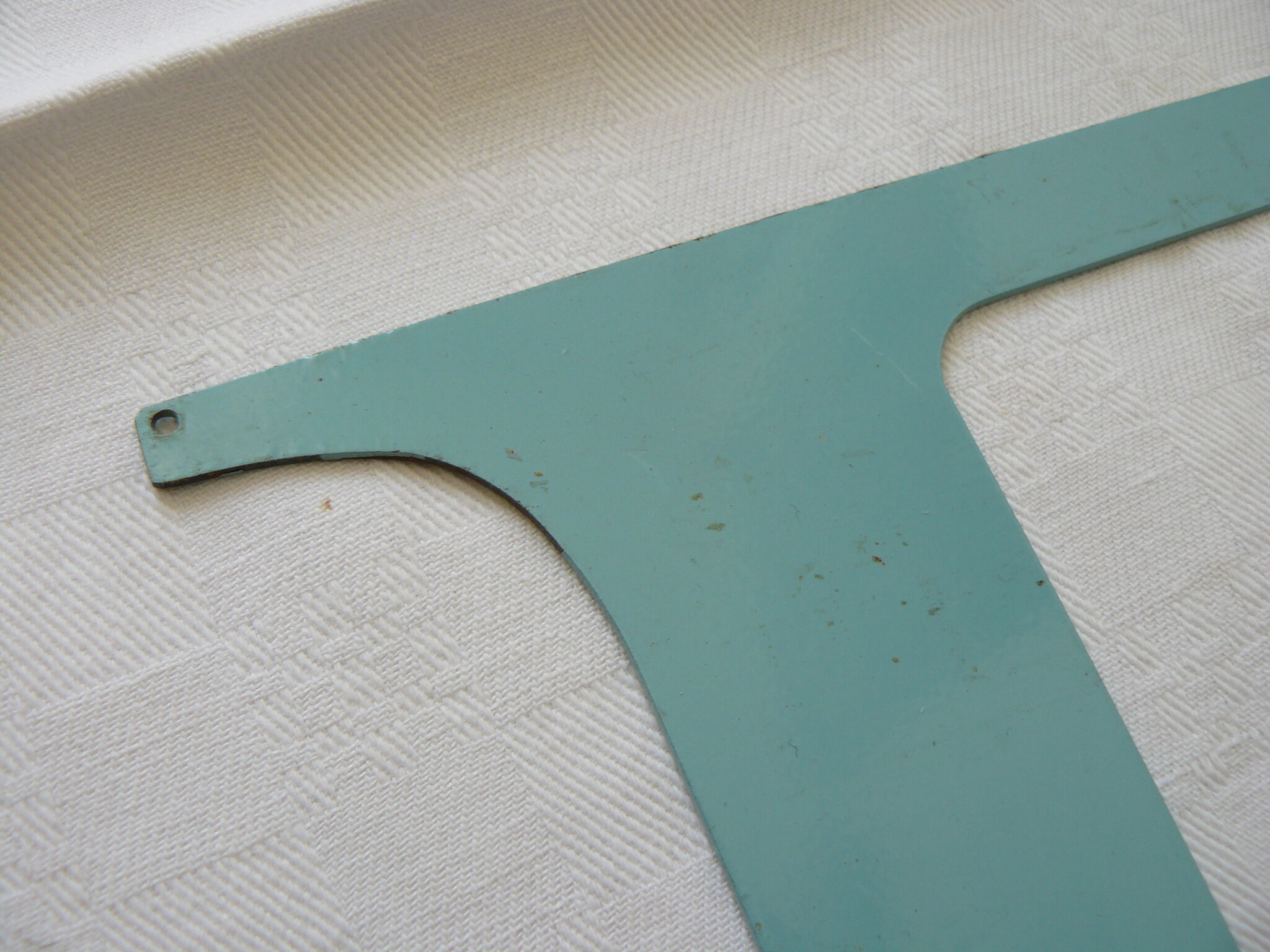 Old letter E painted metal sign