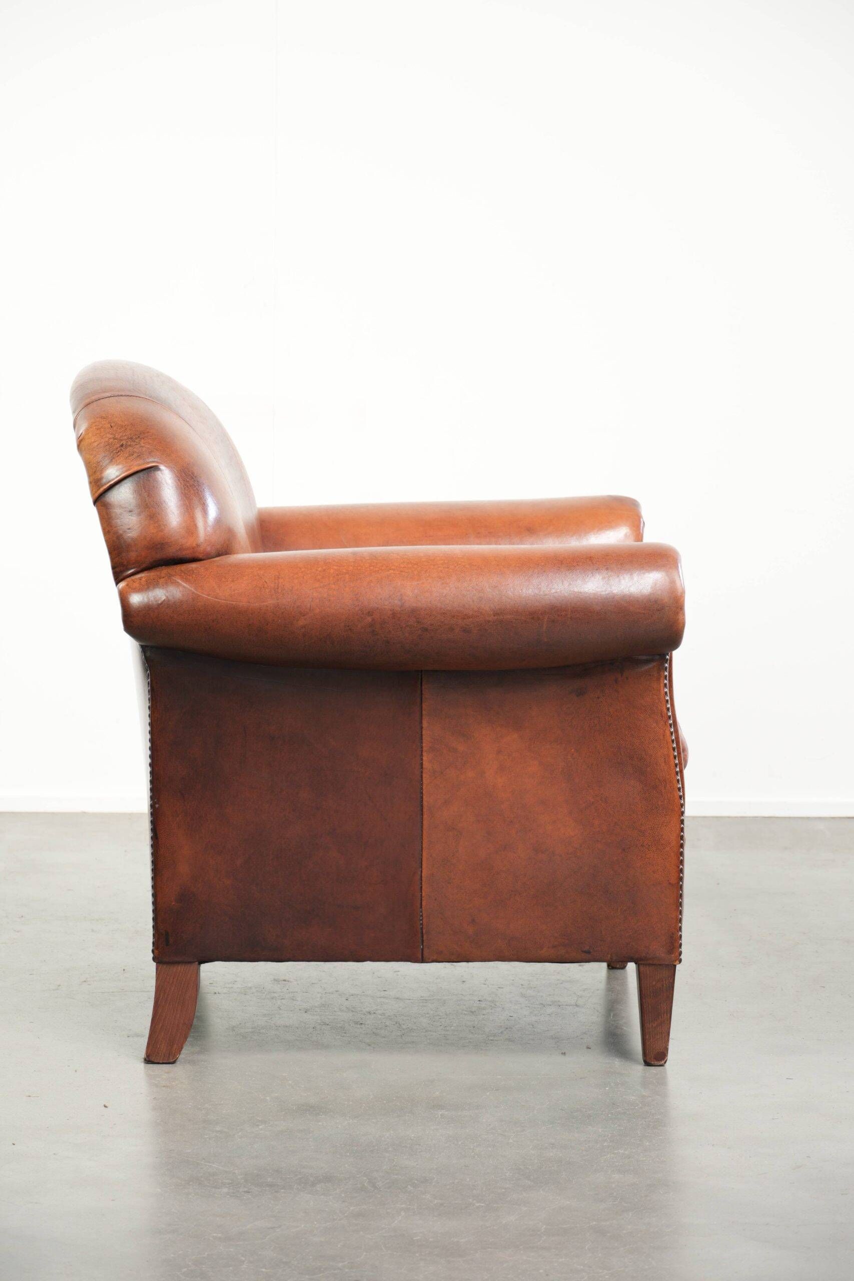 Comfortable vintage sheepskin armchair finished with decorative nails