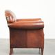Comfortable vintage sheepskin armchair finished with decorative nails