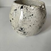 Small speckled ceramic jug in a vintage workshop style.