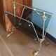 1950s bronze and tinted glass magazine rack with clawed feet