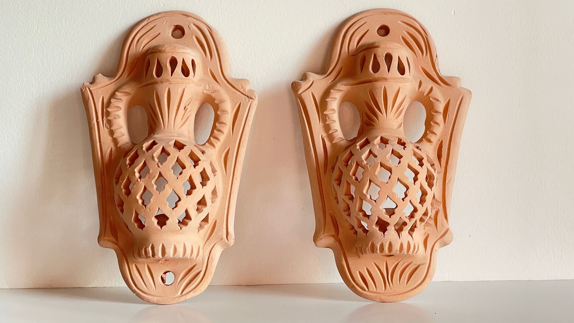 Pair of terracotta wall candle holders