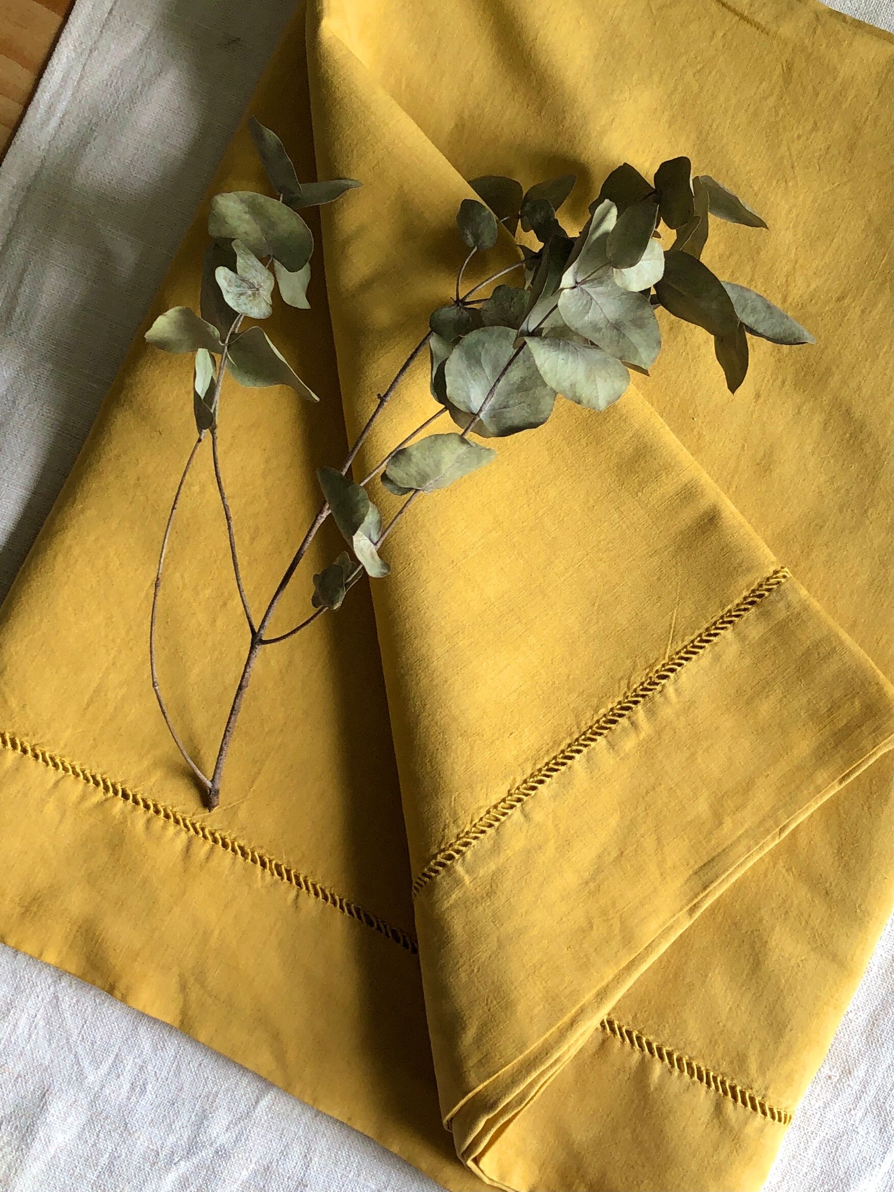 Old linen and cotton sheet tinted in curry yellow