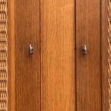 Rattan wardrobe and its compass-legged chest of drawers, 1960
