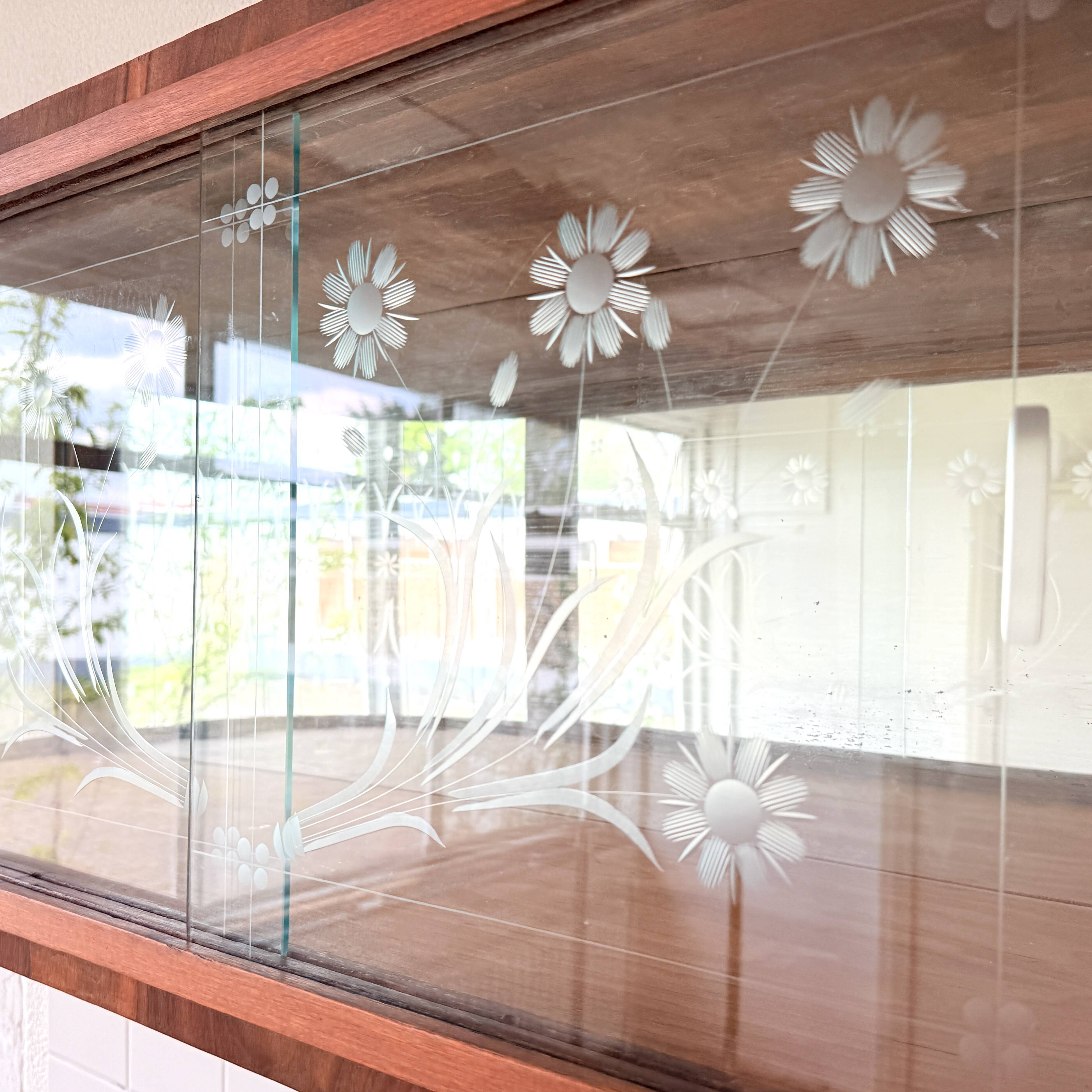 Art Deco-style wall-mounted display cabinet with floral engraving