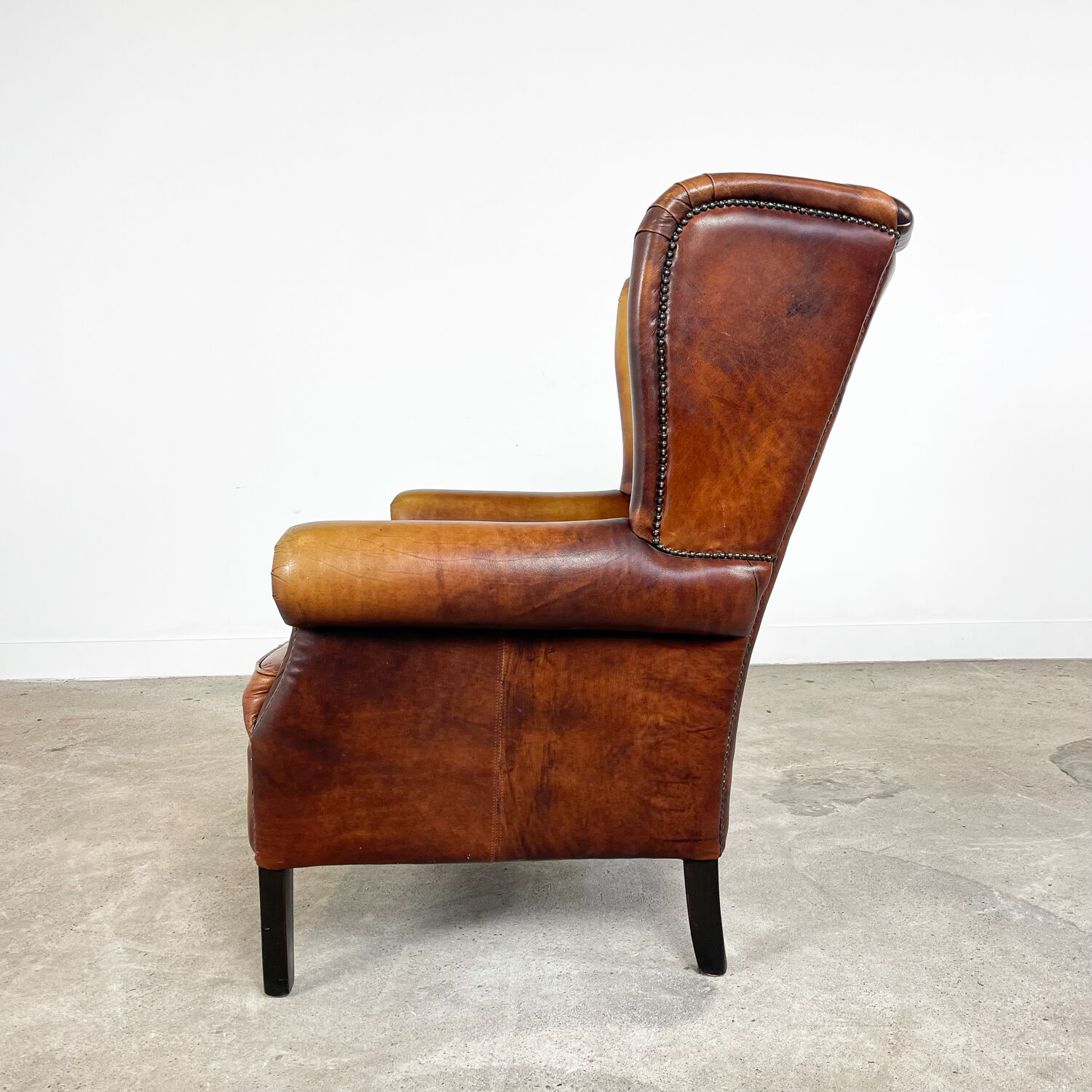 Vintage sheep leather wingback armchair Goor