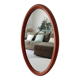 Vintage oval wooden mirror "caramel" from the 1960s.