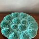 Flat oyster service and 6 splash plates of Gien green celadon