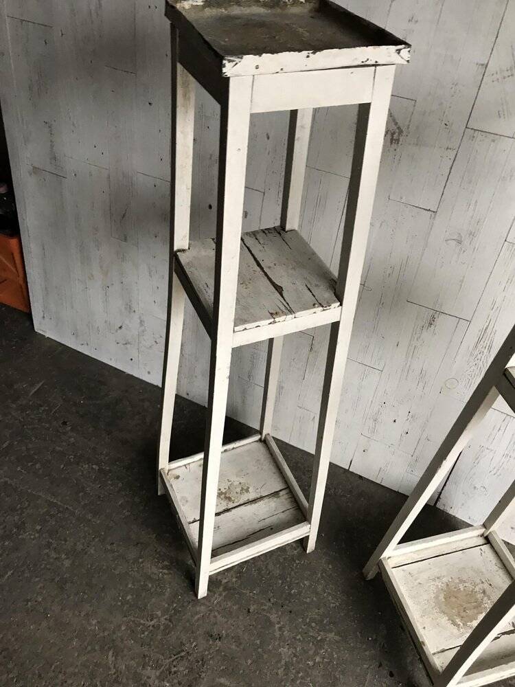 Two white vintage mid-20th century wooden plant stands, 3-tier shelves.