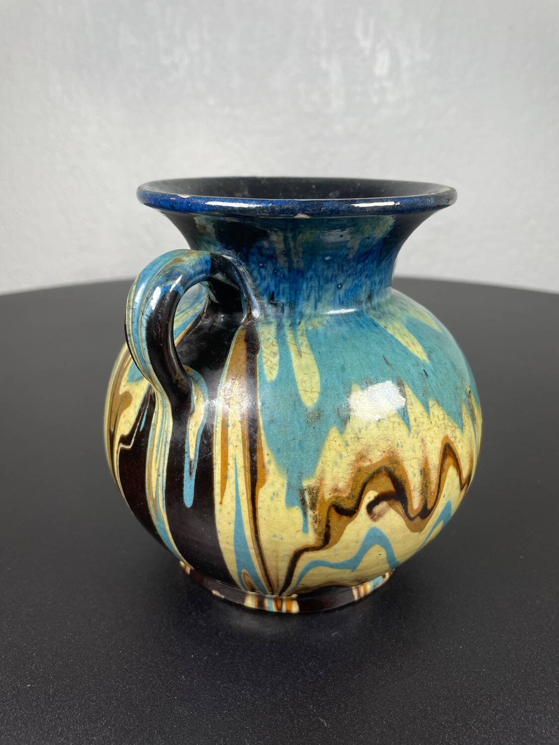 Black ball vase with handle, yellow blue marbled