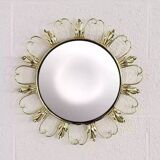 Round mirror on brass frame with scrolls