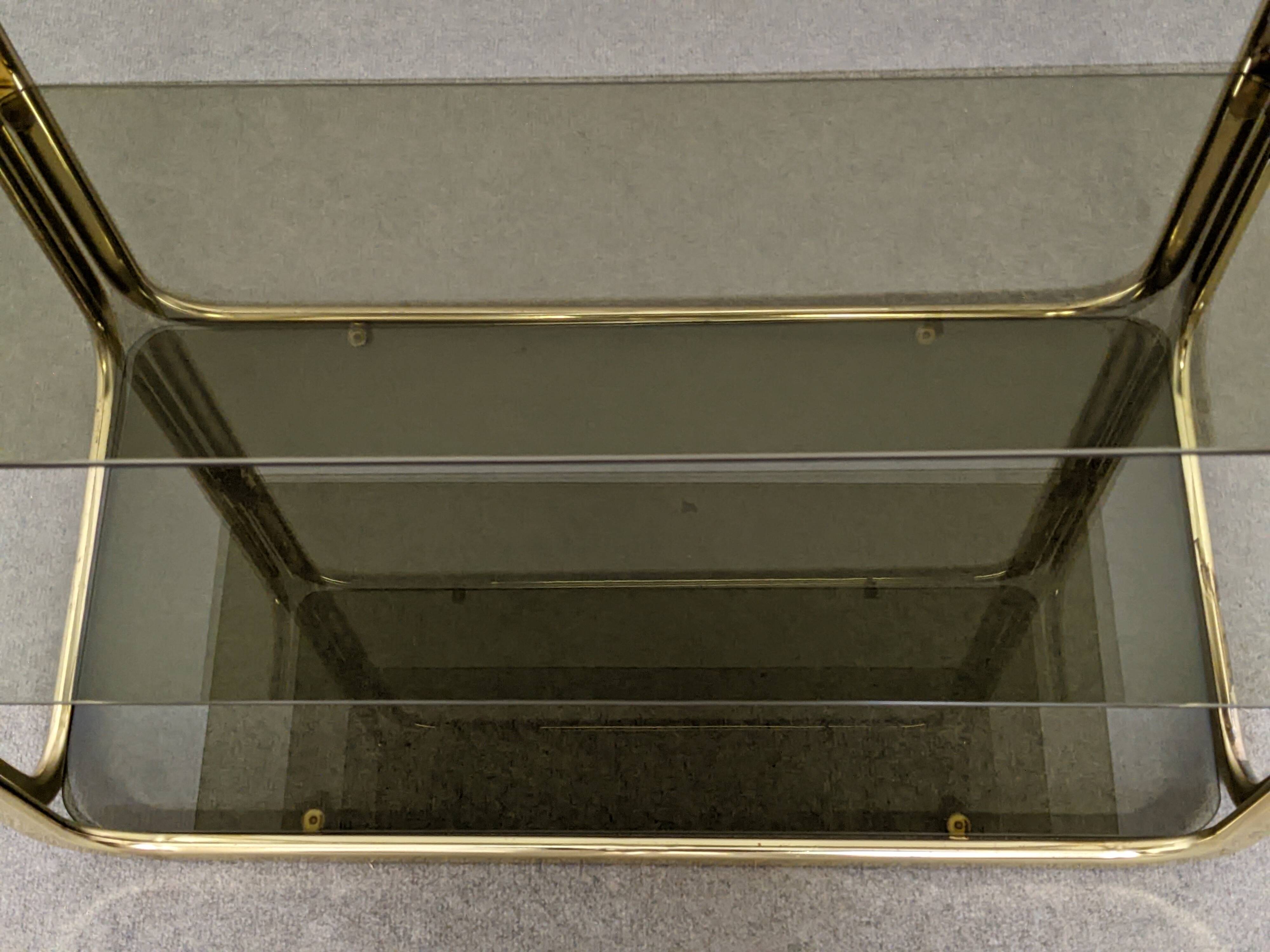 Hollywood Regency gilt metal and smoked glass shelf, Italy circa 1970