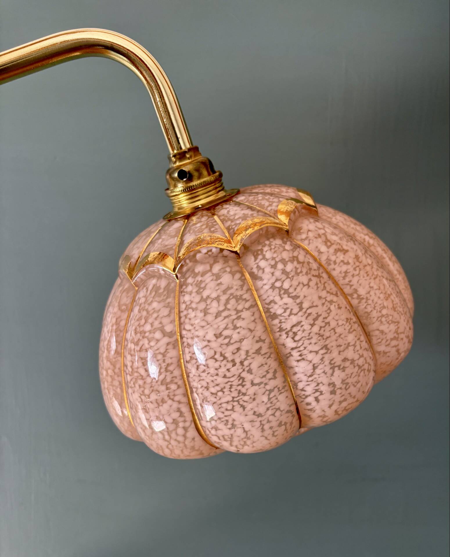 Vintage glass wall light with a pink and gold Clichy globe.