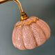 Vintage glass wall light with a pink and gold Clichy globe.