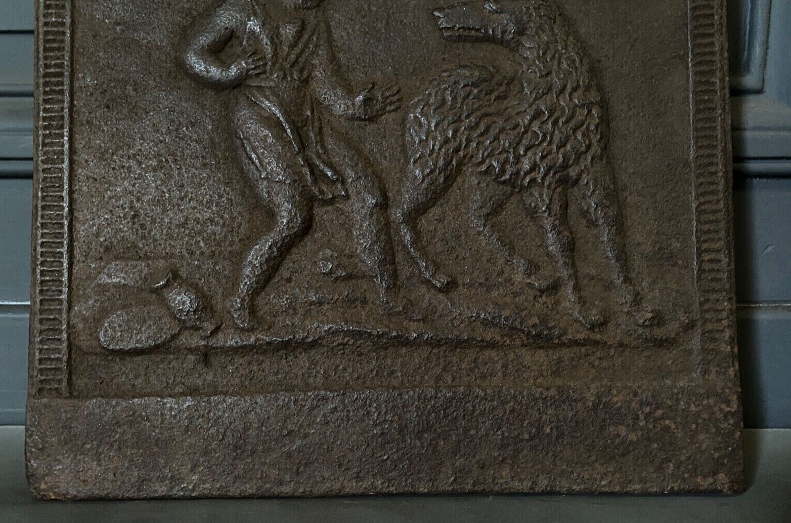EIGHTEENTH CENTURY CAST IRON FIREPLACE PLATE REPRESENTING A WOMAN AND A WOLF