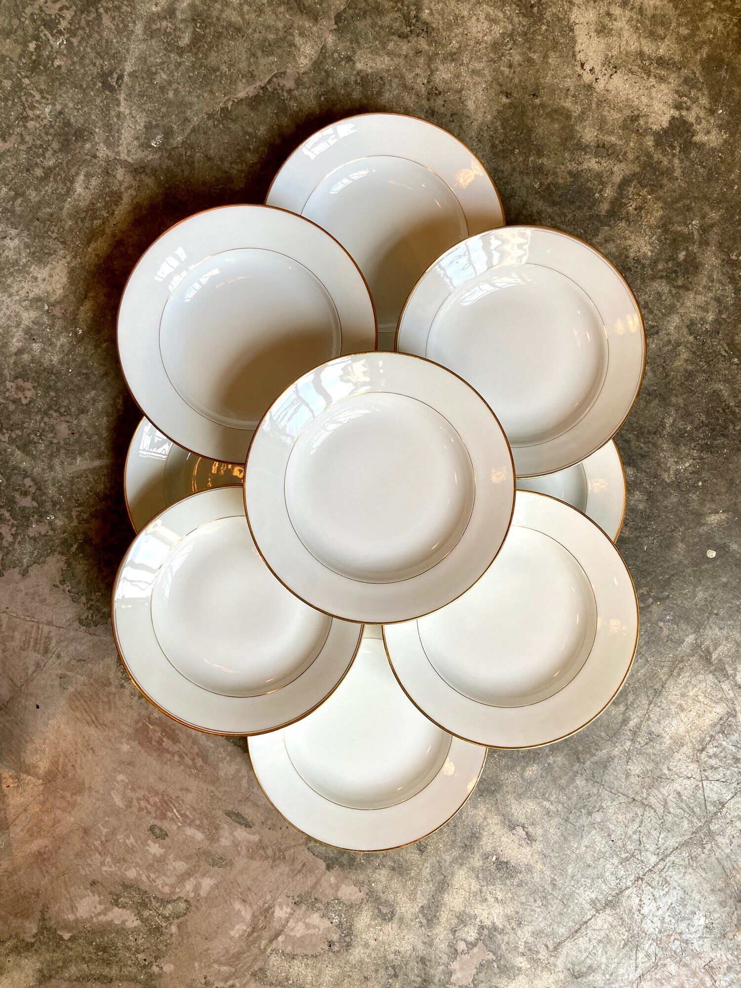 9 hollow plates in white and golden Limoges porcelain