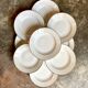 9 hollow plates in white and golden Limoges porcelain