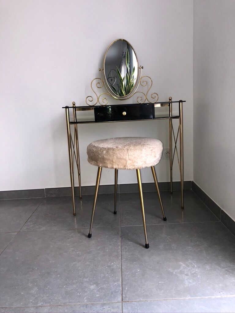 Brass hairdresser, glass and black plastic with its fluffy stool.