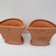 Duo of decorated terracotta wall flowerpots