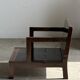 Small low armchair in varnished brown wood
