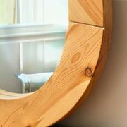 Round mirror in raw wood
