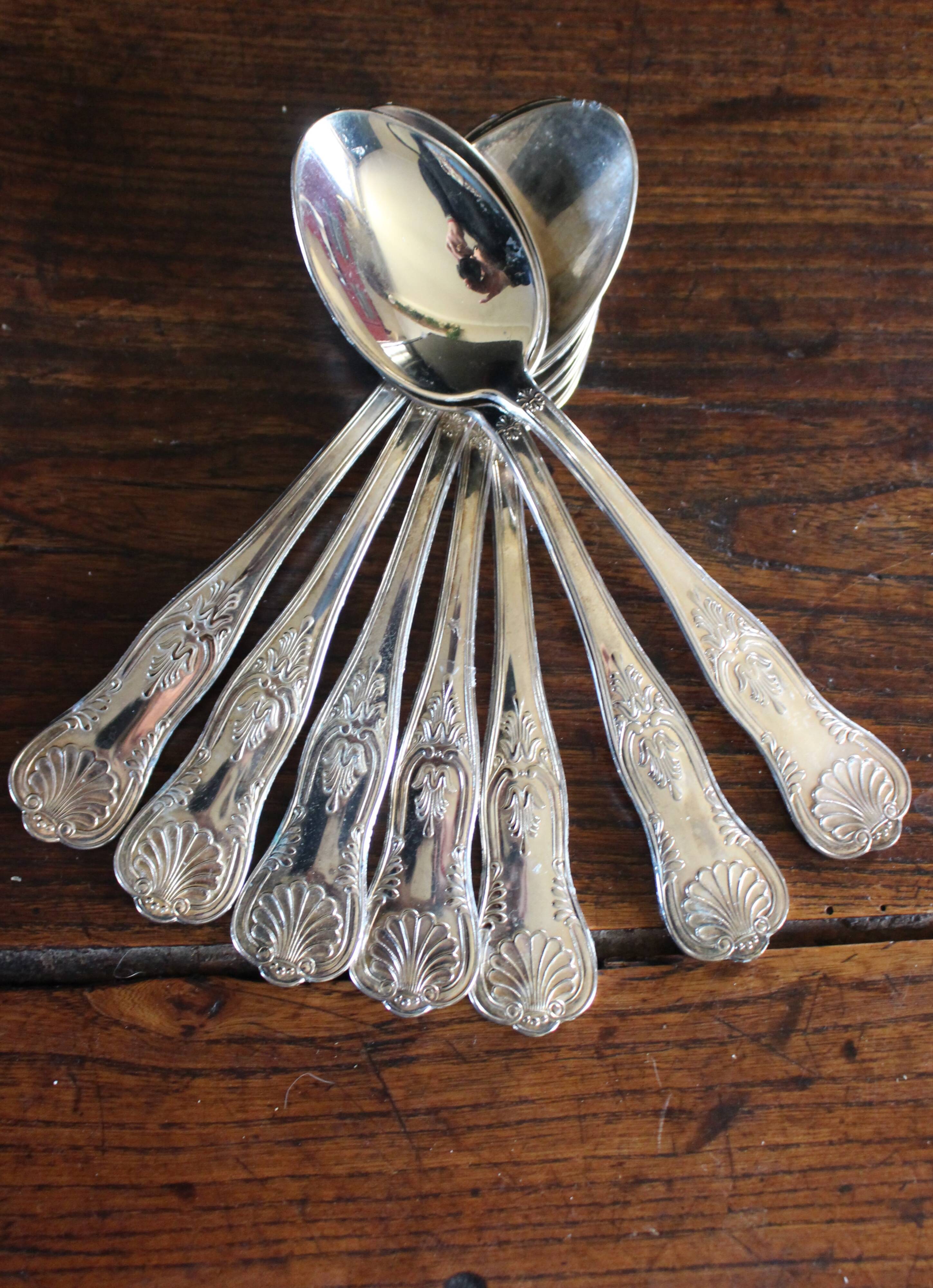 A set of 7 large metal shell spoons