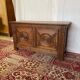 Small antique oak chest with carved panels.