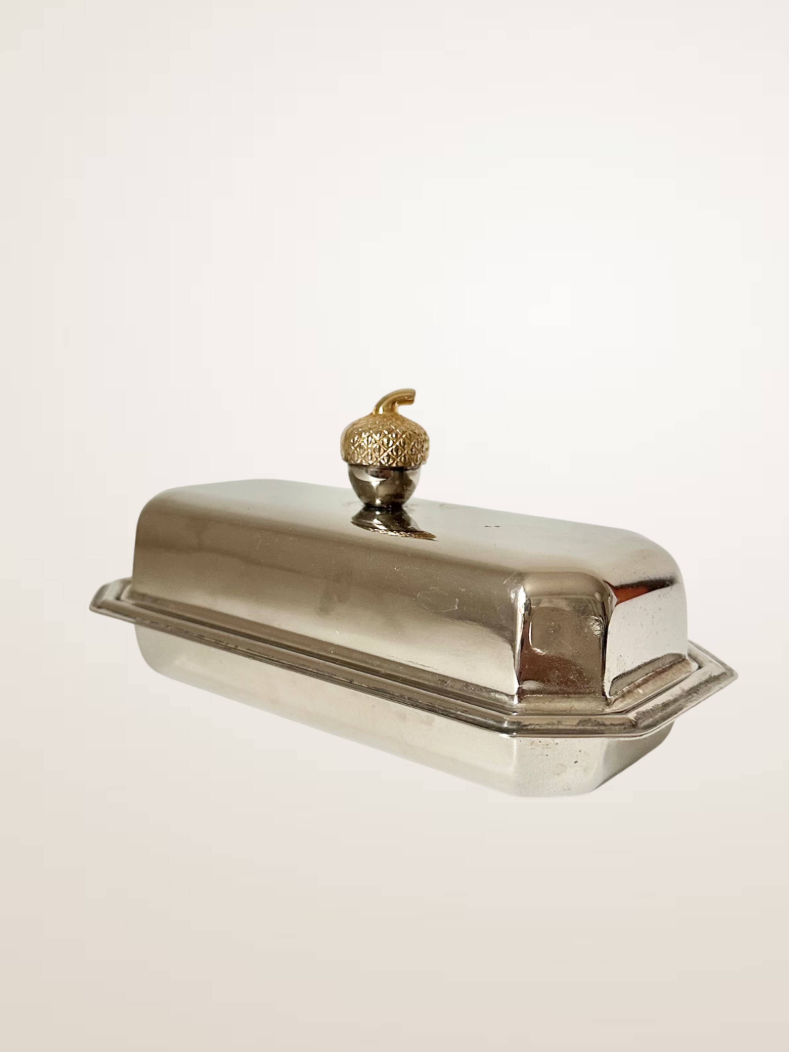 Silver-plated butter dish with a hazelnut knob.