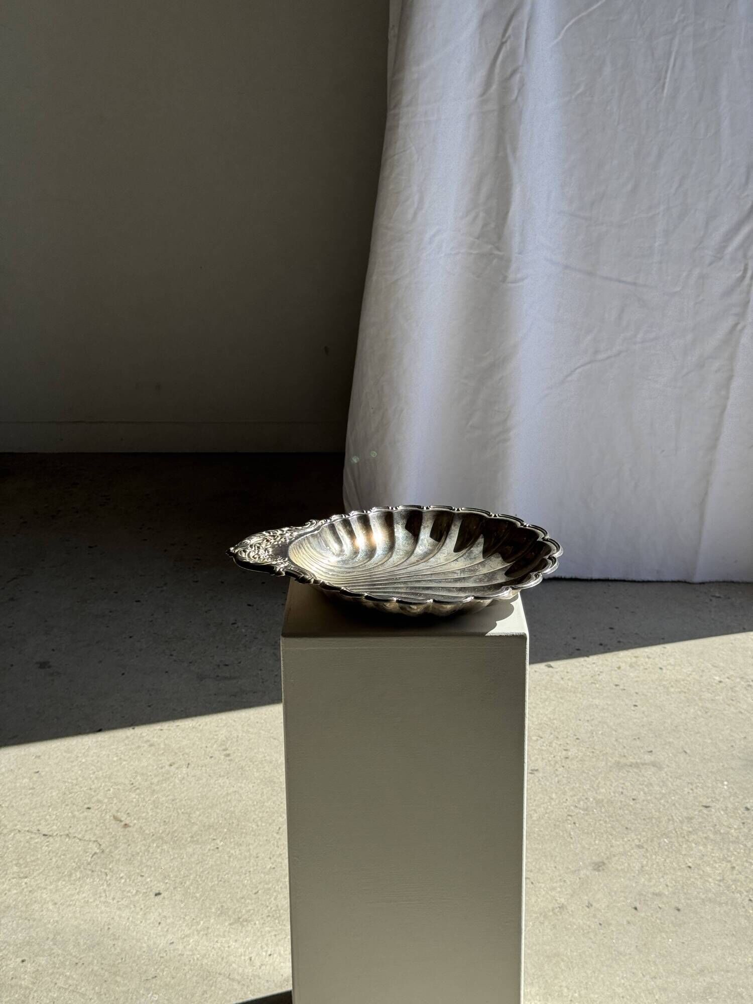 Large antique silver-plated bowl in the shape of a shell.