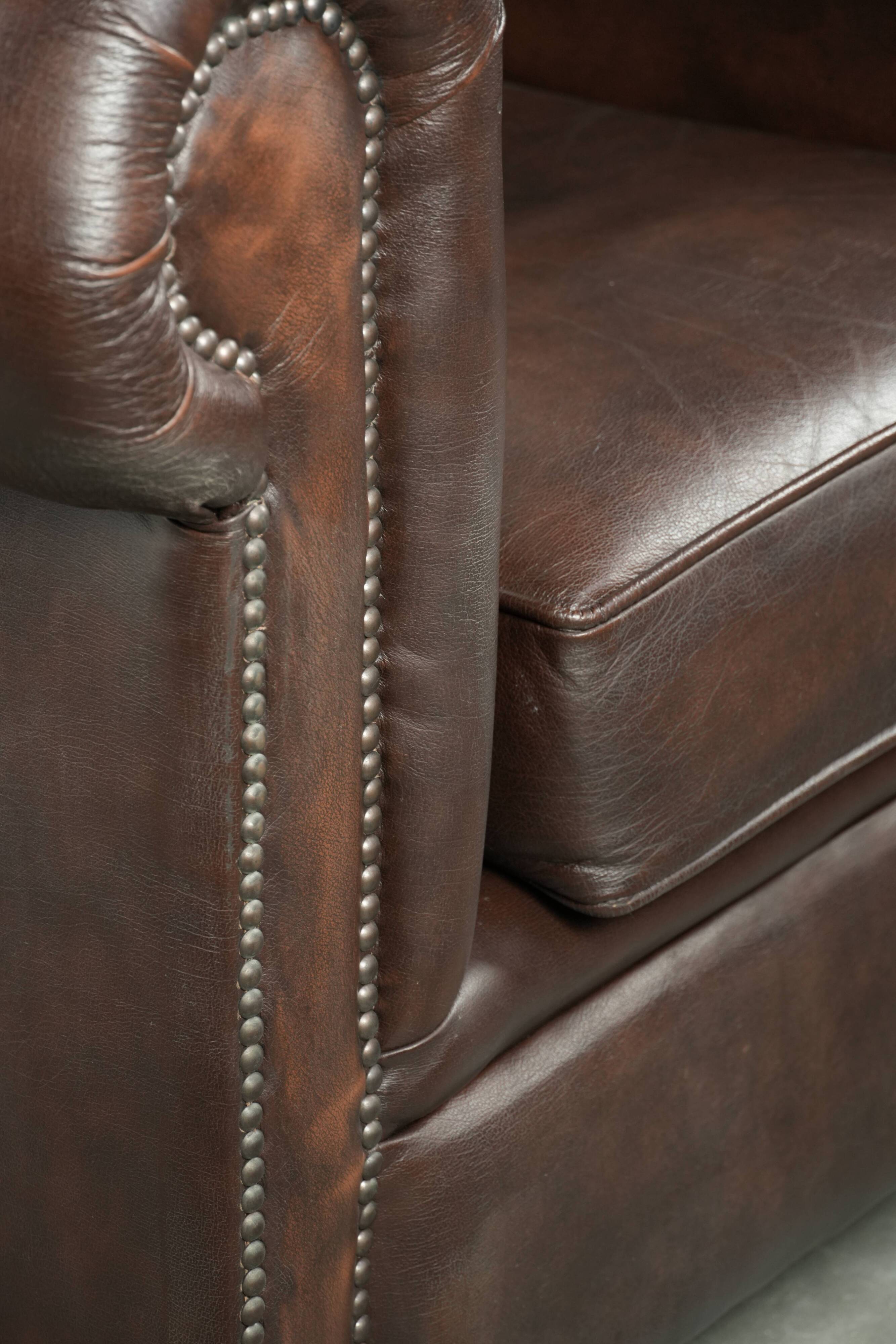 Set of a smooth chesterfield sofa and armchair with a timeless English look