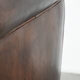 Dark brown vintage club armchair in English style made of sheepskin leather