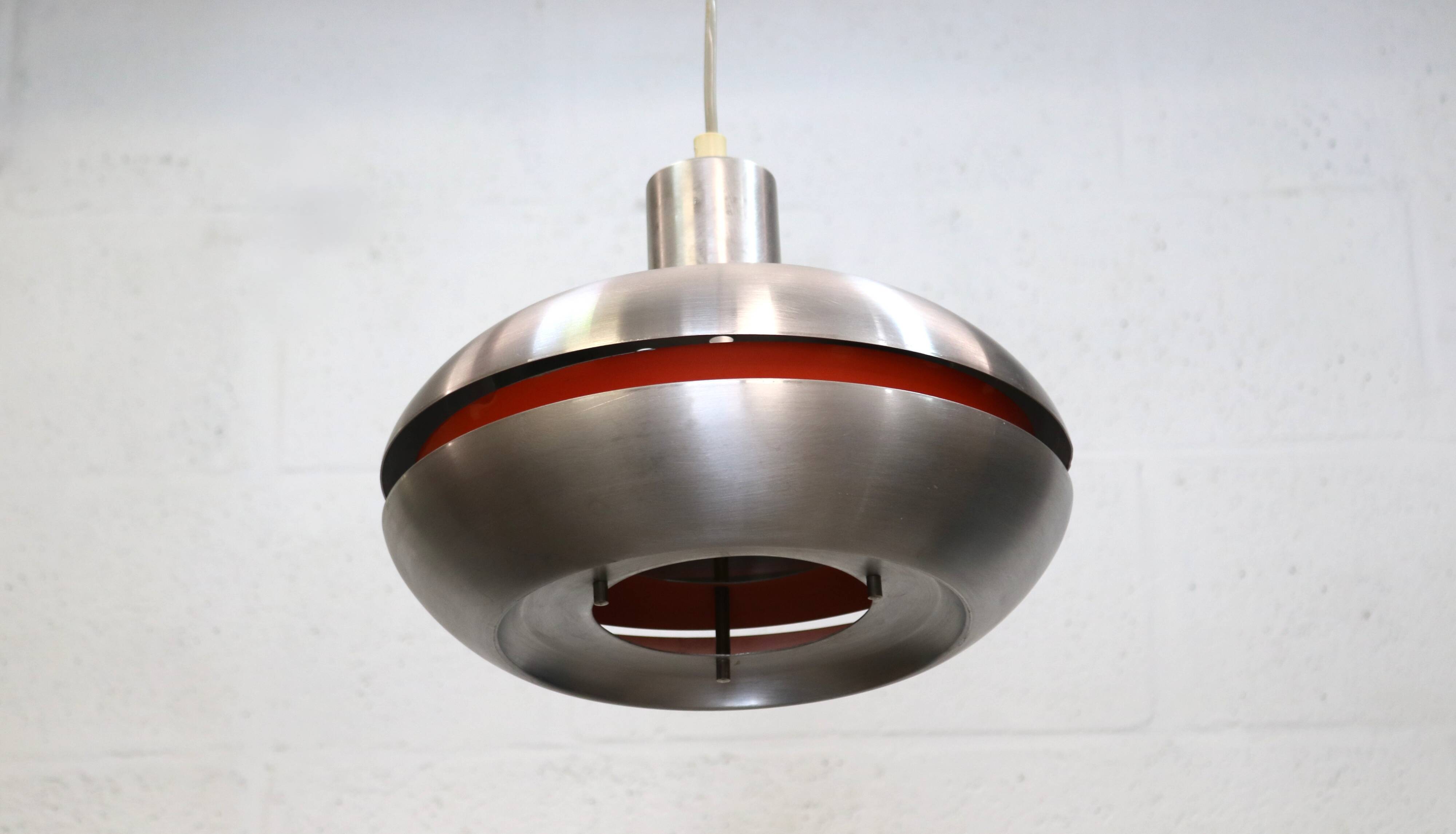 Old Danish space age design lamp in alu and orange inside.