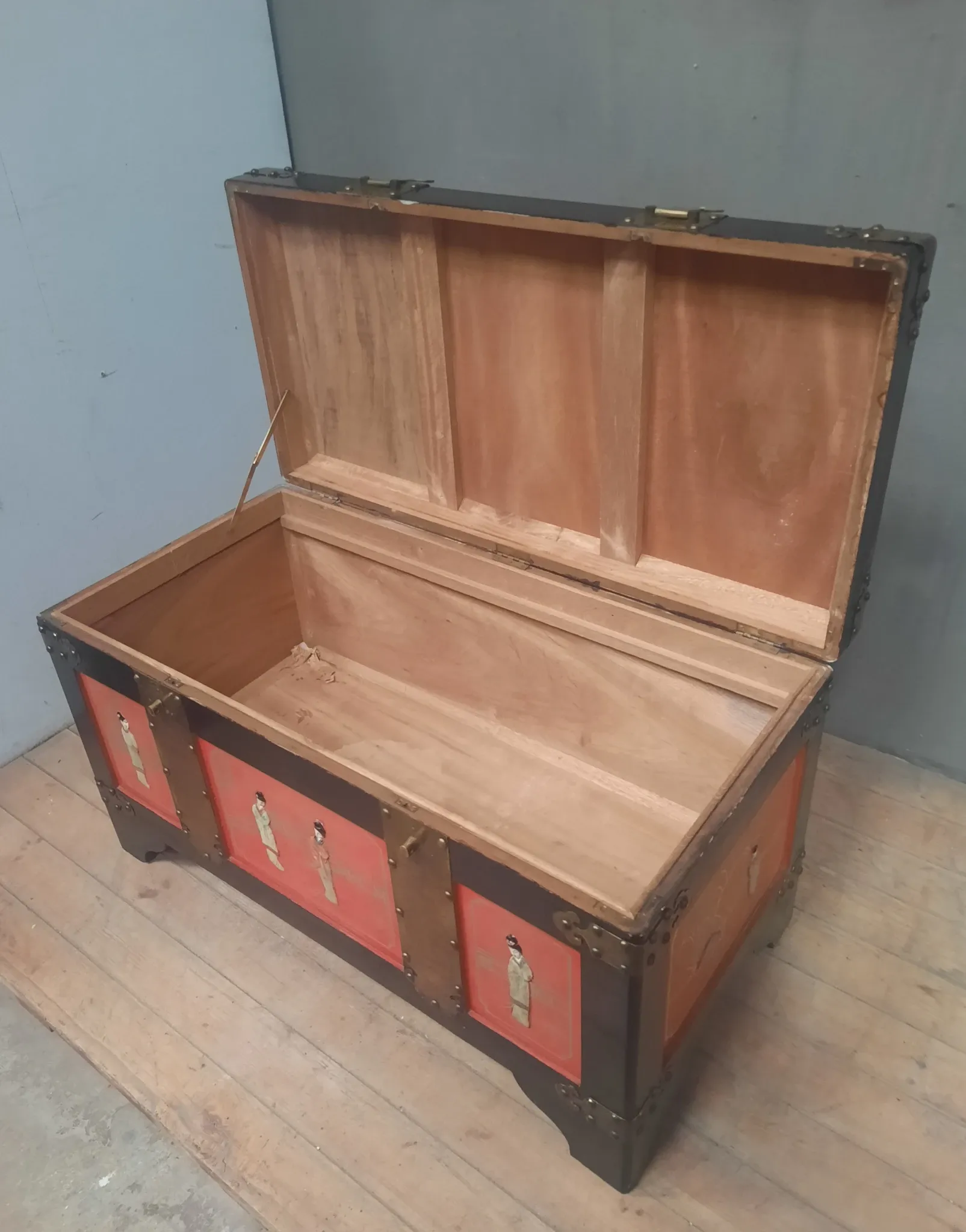 Red lacquered wooden mallet from the Far East.