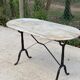 Table de bistrot marbre ovale et acier noir 4 couverts 120cm