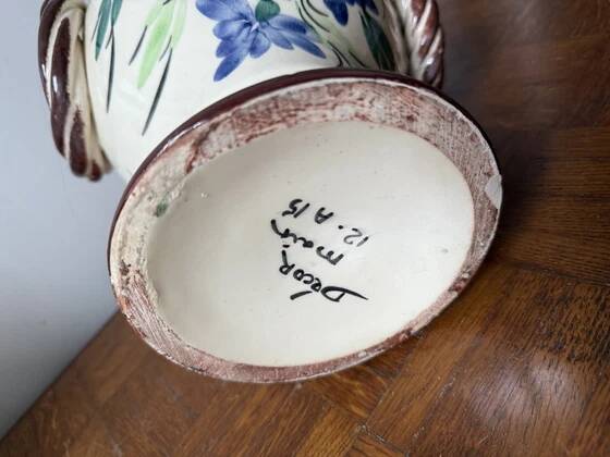 Ceramic vase with hand-painted floral decoration.