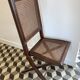 Vintage folding chair with cane seat in dark mahogany wood