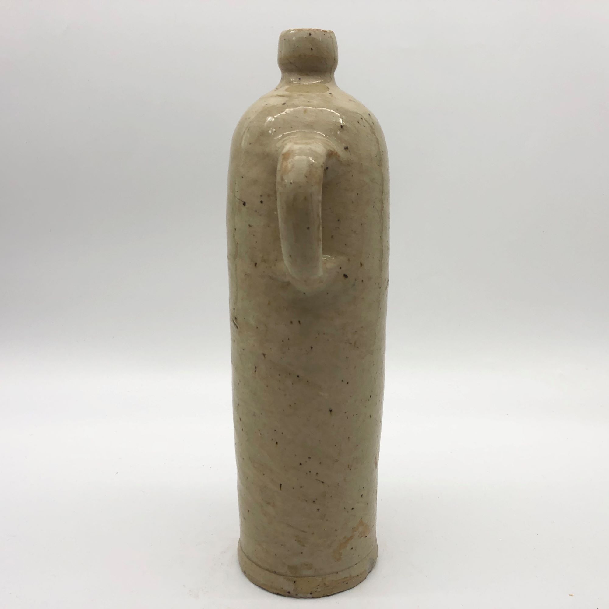 Old hot water bottle in glazed stoneware, beige color
